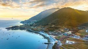 an aerial view of a harbor with boats in the water at Namhae Harbor Resort in Namhae