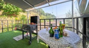 a table with bottles and a grill on a balcony at Daeboodo Podohyangki Pension in Ansan +12 photos