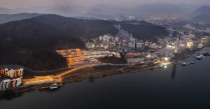 an aerial view of a city next to the water at night at Gaypeng Poolvilla Lisum Five Penison in Gapyeong