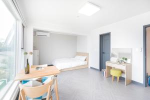 a bedroom with a bed and a desk and a table at Incheon donggeumdo hanguk villa in Incheon