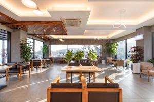 a restaurant with tables and chairs and large windows at Yeosu Palette Pension in Yeosu