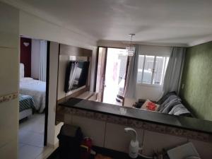 a living room with a couch and a mirror at Casa Inteira Oliveira in São José dos Pinhais