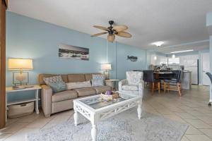 a living room with a couch and a table at Buena Vista 205 in Gulf Shores