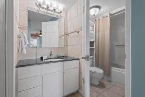 a bathroom with a sink and a toilet at Buena Vista 205 in Gulf Shores +27 photos