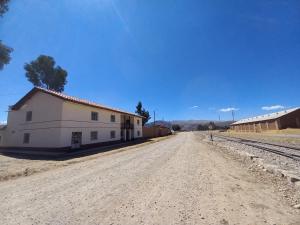 a dirt road in front of a white building at Casa Rosita Sausa in Jauja