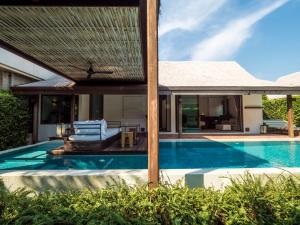 a villa with a swimming pool and a house at Putahracsa Hua Hin in Hua Hin