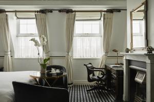 a bedroom with a bed and a desk and a desk at 41 in London +85 photos