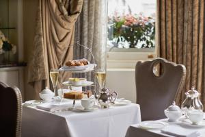 a table with a plate of food on it at Egerton House in London