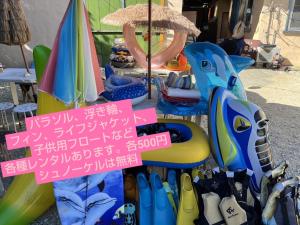 a group of beach chairs and umbrellas on display at やどバンブー in Hateruma
