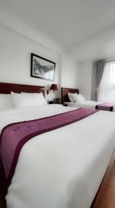 Postel nebo postele na pokoji v ubytování Sapa Lake View Hotel