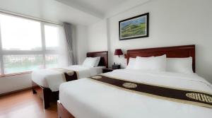 Postel nebo postele na pokoji v ubytování Sapa Lake View Hotel