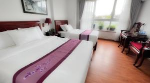 Postel nebo postele na pokoji v ubytování Sapa Lake View Hotel