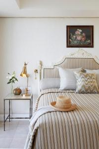 a bedroom with a bed with a hat on it at Twelve Apostles Hotel & Spa in Cape Town