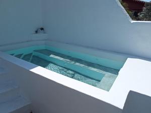 a swimming pool in the middle of a white house at Kyklades Sensation Private Plunge Pool Romantic Suite in Artemida
