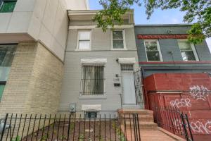 a house with a red door and a fence at Negin 2903 - Basement Unit in Washington