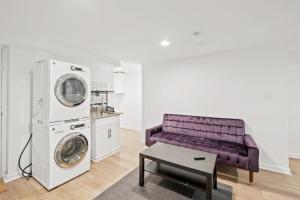 a living room with a purple couch and a washing machine at Negin 2903 - Basement Unit in Washington +10 photos