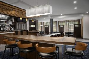 a large dining room with a large table and chairs at Courtyard by Marriott Philadelphia Bensalem in Bensalem