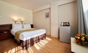 a hotel room with a bed and a television at Xima Arequipa Crismar in Arequipa +63 photos