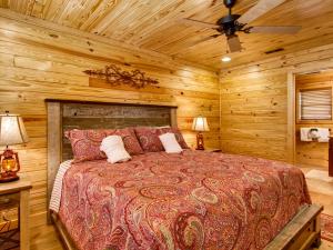 a bedroom with a bed in a log cabin at River Romance #2328 in Pigeon Forge