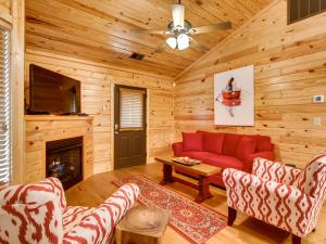 a living room with a red couch and a fireplace at River Romance #2328 in Pigeon Forge