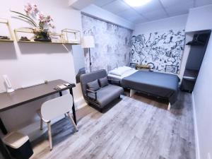 a room with a bed and a desk and a chair at Pillows CoLiving in Hong Kong