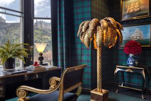 a room with a desk and a chair and a floor lamp at 100 Princes Street in Edinburgh