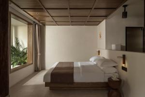 Postel nebo postele na pokoji v ubytování Shijing Hotel in Dali-大理柿井美宿