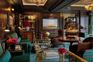 a living room with couches and tables at 100 Princes Street in Edinburgh