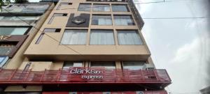 a tall building with a clock on the side of it at Clarks Inn Express Ludhiana in Ludhiana