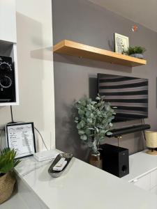 a white desk with a phone and a vase of flowers at KaribuBnb in Lapu Lapu City +14 photos