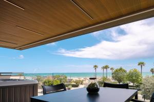 a patio with a table and chairs and the ocean at ArtRock Apartments in Giulianova