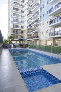a swimming pool in front of a building at Luxurious 3 Bed 4 Bath Condo in Nairobi