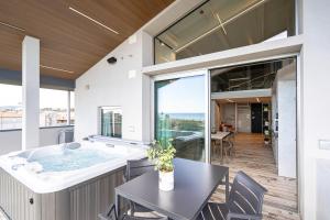 a large bathroom with a tub and a table and chairs at ArtRock Apartments in Giulianova