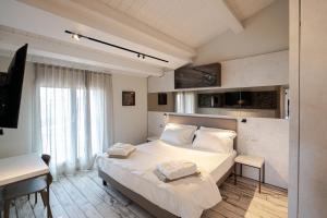 a bedroom with a large bed with white sheets at ArtRock Apartments in Giulianova +239 photos