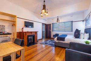 a bedroom with a bed and a fireplace and a table at Dazzle Stay in East London