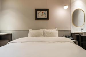 Postel nebo postele na pokoji v ubytování Yangju Hotel NO25