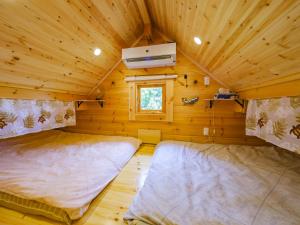 Postel nebo postele na pokoji v ubytování UMIOTO log
