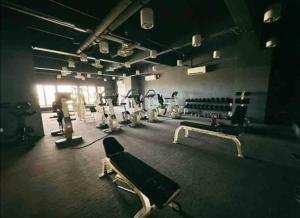 a gym with several treadmills and machines at Era Amazing Manhattan Suite, ITCC in Penampang