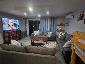 a living room with a couch and a flat screen tv at 62 on Tuzi Gazi in Richards Bay