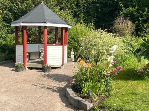 a red and white gazebo in a garden at Brittas Country House in Munka-Ljungby +9 photos