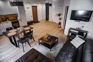 a living room with a couch and a table at Hales Old Town Urban Apartments in Vilnius
