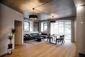 a living room with a couch and a table at Hales Old Town Urban Apartments in Vilnius