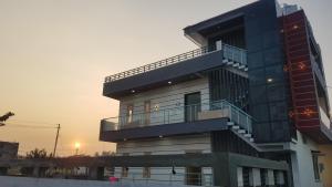a building with a balcony on the side of it at Padmaa Hampi Echo Villa in Hampi