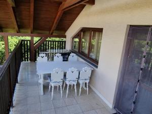 a white table and chairs on a porch with a table at Vila Danka in Veľký Meder