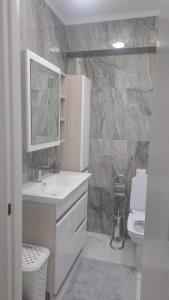 ein weißes Badezimmer mit Waschbecken und Toilette in der Unterkunft Уютный Дом in Chişinău