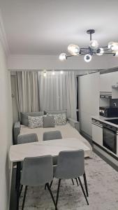 a bedroom with a large bed and two chairs at Уютный Дом in Chişinău +44 photos