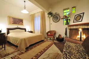a bedroom with a bed and a fireplace at Guesthouse Chrysa in Kalavrita