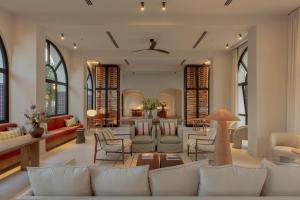 a living room with white couches and chairs at Elisabeth by the Sea Hotel in Tossa de Mar