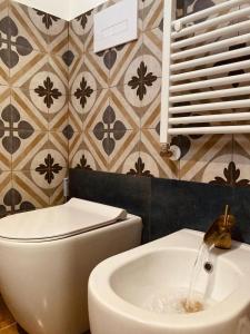 a bathroom with a toilet and a sink at Domus Mylae in Milazzo