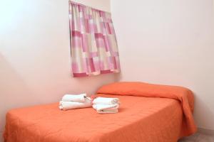 Postel nebo postele na pokoji v ubytování Residence Arco delle Rose